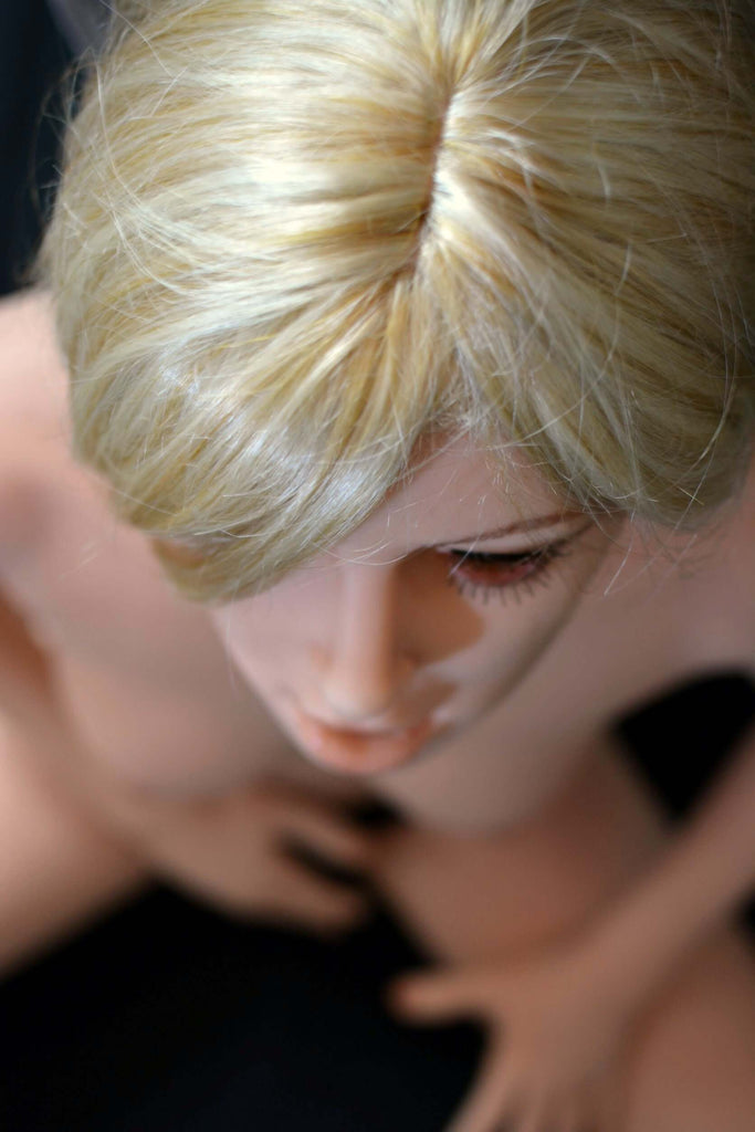 Blonde EscortDoll Chlea mit kleinen, nackten Brüsten in laziver Pose